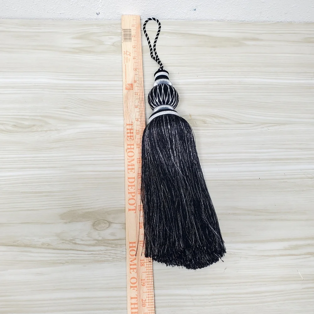 A Set of Black and Silvertone Tassel Curtain Accents with Sculptural Design, 18